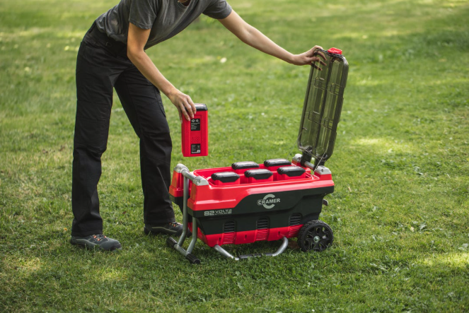 Red and Black Cramer 82V Professional 6 Slot Rapid Charging Station in use