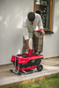 Red and Black Cramer 82V Professional 6 Slot Rapid Charging Station in use