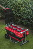 Red and Black Cramer 82V Professional 6 Slot Rapid Charging Station in use