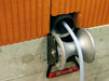 RUNPOTEC cable guide roller - shaft is ideally suited for mounting in shafts to pull cables gently around corners with the least possible resistance. Example photo of shaft roller attached to a concrete wall