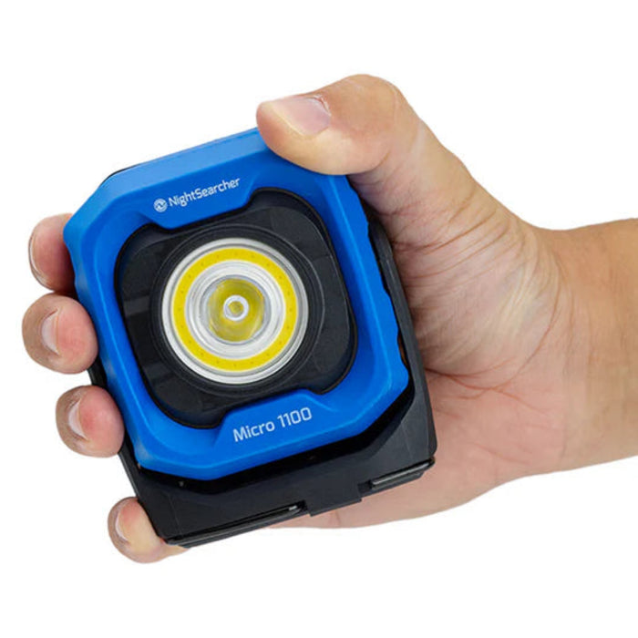 Blue and Black NightSearcher Micro 1100 - 1100 Lumens - Rechargeable Work Light - in person's hand