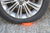Red Pulsar Pro Rechargeable Hazard Warning Light by NightSearcher in use under car tyre