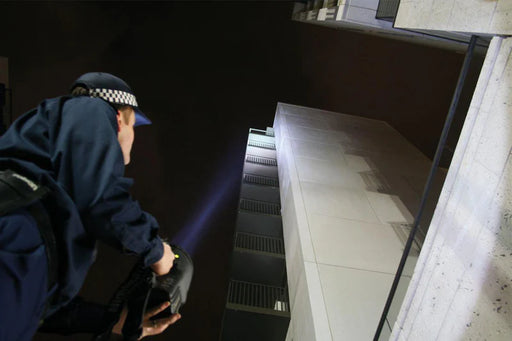 Black NightSearcher Panther XHP-X rechargeable searchlight in use