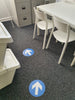 Blue and white arrow floor stickers  through office on carpet