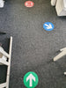 Blue and green floor stickers showing different directions